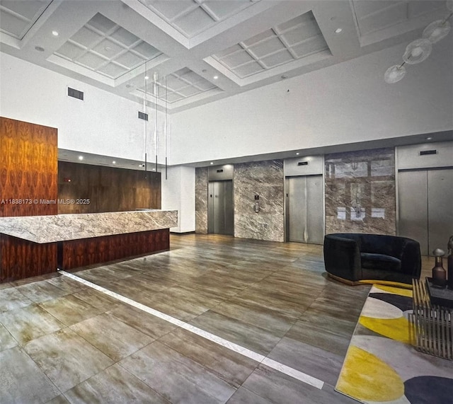 10 Aragon Ave Unit 1118, Coral Gables, FL 33134 - reception area featuring a towering ceiling, coffered ceiling, and beamed ceiling