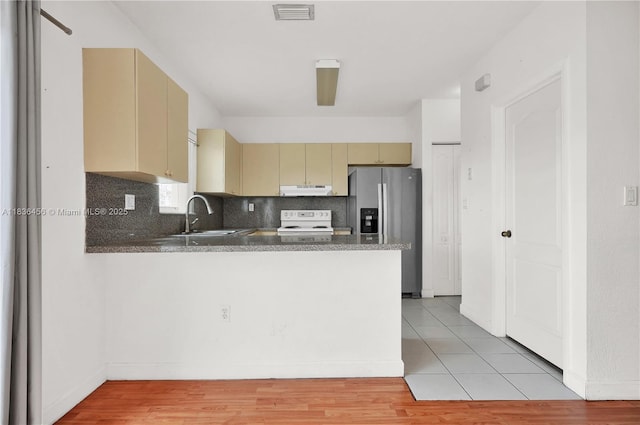 14815 SW 9th Ln, Miami, FL 33194 - kitchen with stainless steel fridge with ice dispenser, cream cabinetry, white electric stove, under cabinet range hood, and a peninsula