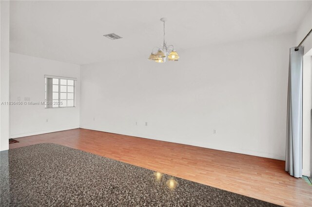 14815 SW 9th Ln, Miami, FL 33194 - spare room featuring a chandelier and wood finished floors