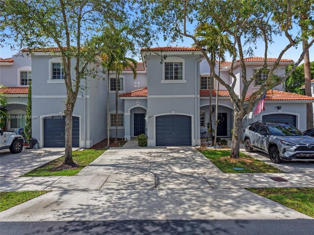 14815 SW 9th Ln, Miami, FL 33194 - mediterranean / spanish home featuring a tiled roof, driveway, stucco siding, and a garage