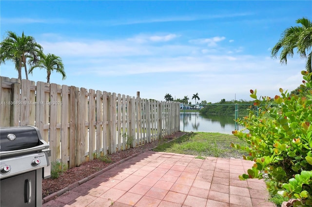 14815 SW 9th Ln, Miami, FL 33194 - fenced backyard featuring a patio area, grilling area, and a water view