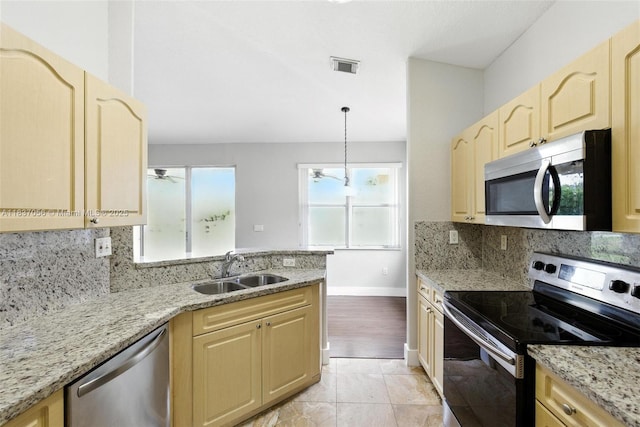 8899 NW 169th Ter, Hialeah, FL 33018 - kitchen featuring stainless steel appliances, light brown cabinets, tasteful backsplash, and ceiling fan