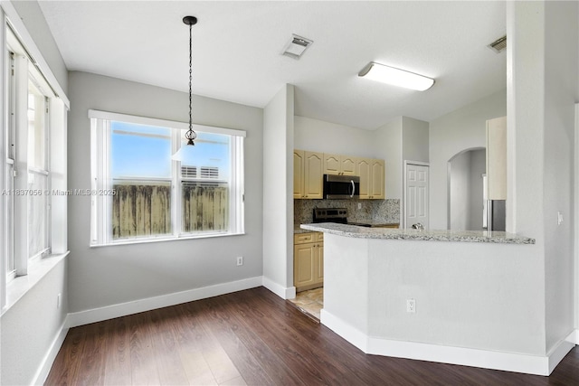 8899 NW 169th Ter, Hialeah, FL 33018 - kitchen with appliances with stainless steel finishes, arched walkways, dark wood-style flooring, and decorative backsplash