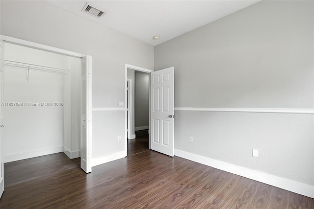 8899 NW 169th Ter, Hialeah, FL 33018 - unfurnished bedroom featuring dark wood-type flooring and a closet