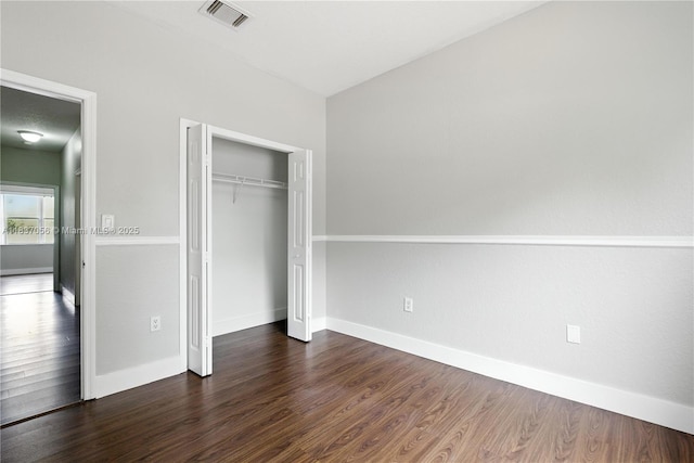 8899 NW 169th Ter, Hialeah, FL 33018 - unfurnished bedroom with dark wood finished floors and a closet