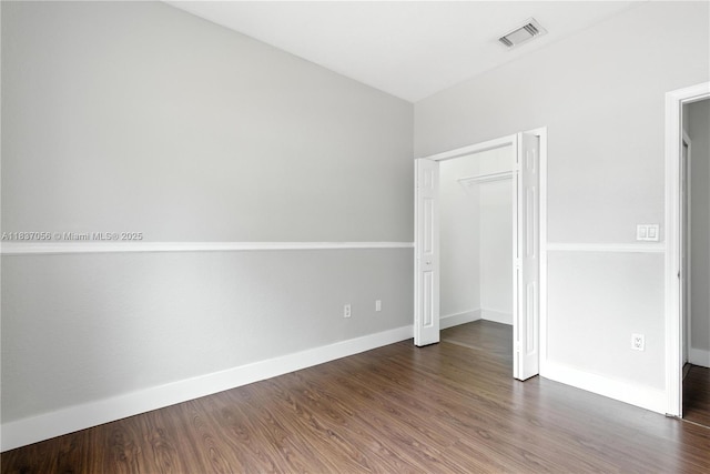 8899 NW 169th Ter, Hialeah, FL 33018 - unfurnished bedroom featuring baseboards and wood finished floors
