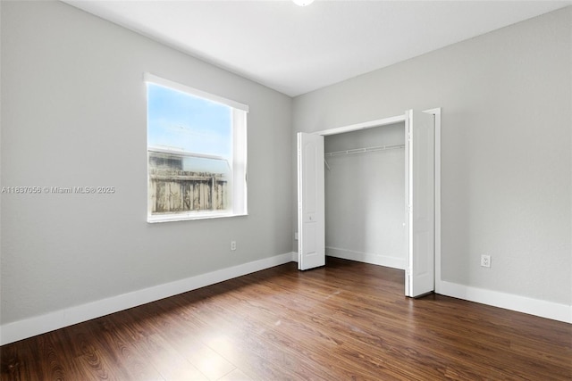 8899 NW 169th Ter, Hialeah, FL 33018 - unfurnished bedroom featuring wood finished floors and a closet