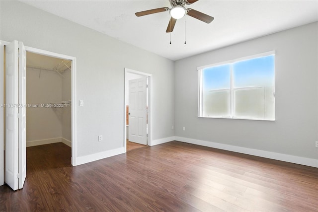 8899 NW 169th Ter, Hialeah, FL 33018 - unfurnished bedroom featuring a spacious closet, wood finished floors, and ceiling fan