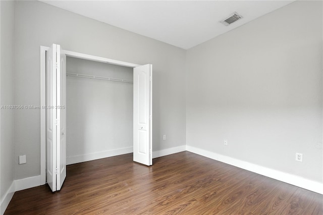 8899 NW 169th Ter, Hialeah, FL 33018 - unfurnished bedroom featuring dark wood-type flooring and a closet