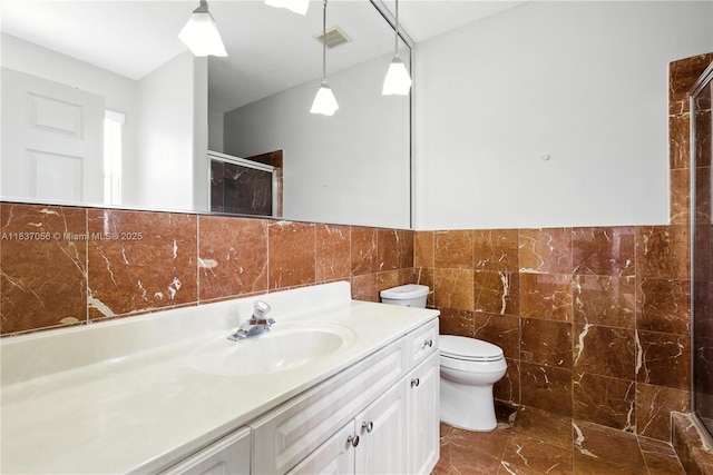 8899 NW 169th Ter, Hialeah, FL 33018 - full bath with tile walls, vanity, a shower stall, marble finish floors, and a wainscoted wall