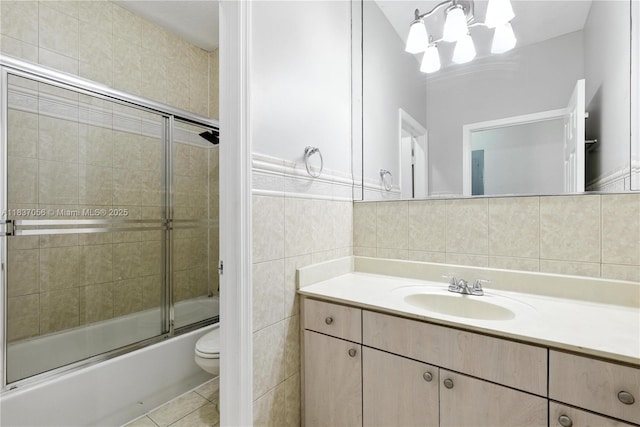8899 NW 169th Ter, Hialeah, FL 33018 - full bathroom with tile walls, vanity, enclosed tub / shower combo, and tile patterned flooring