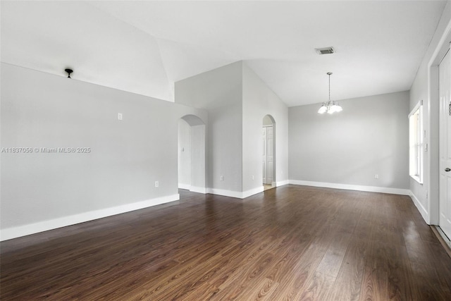 8899 NW 169th Ter, Hialeah, FL 33018 - unfurnished room featuring arched walkways, a chandelier, lofted ceiling, and dark wood-style flooring