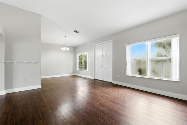 8899 NW 169th Ter, Hialeah, FL 33018 - unfurnished room with a chandelier and dark wood finished floors