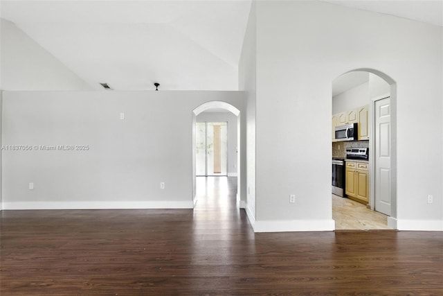 8899 NW 169th Ter, Hialeah, FL 33018 - unfurnished room with vaulted ceiling, light wood-style floors, and arched walkways