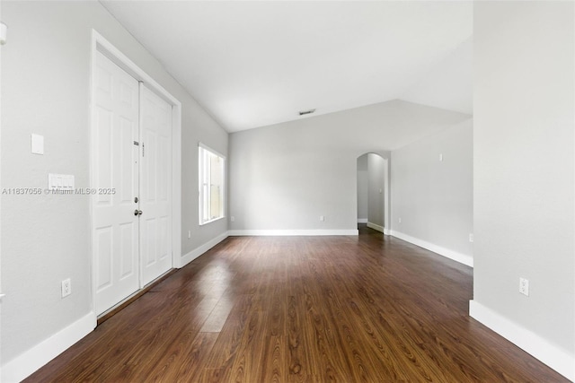 8899 NW 169th Ter, Hialeah, FL 33018 - unfurnished room with arched walkways, dark wood-type flooring, and vaulted ceiling