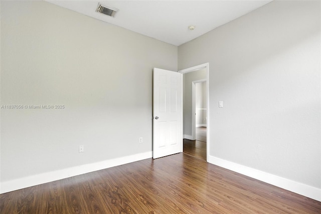 8899 NW 169th Ter, Hialeah, FL 33018 - empty room featuring baseboards and wood finished floors