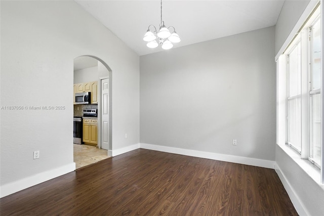 8899 NW 169th Ter, Hialeah, FL 33018 - unfurnished room with arched walkways, light wood-style floors, vaulted ceiling, a chandelier, and healthy amount of natural light
