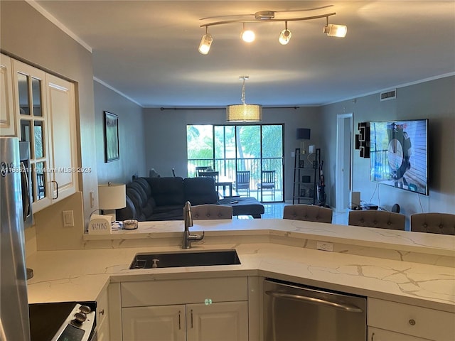 2205 S Cypress Bend Dr Unit 302, Pompano Beach, FL 33069 - kitchen featuring stainless steel appliances, open floor plan, white cabinets, light stone counters, and crown molding