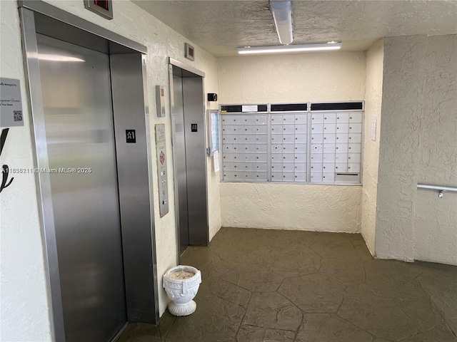 2205 S Cypress Bend Dr Unit 302, Pompano Beach, FL 33069 - hallway with elevator, a textured wall, mail area, and a textured ceiling