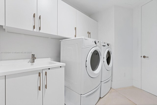18555 Collins Ave Unit 2003, Sunny Isles Beach, FL 33160 - laundry room with cabinet space, independent washer and dryer, and light tile patterned floors