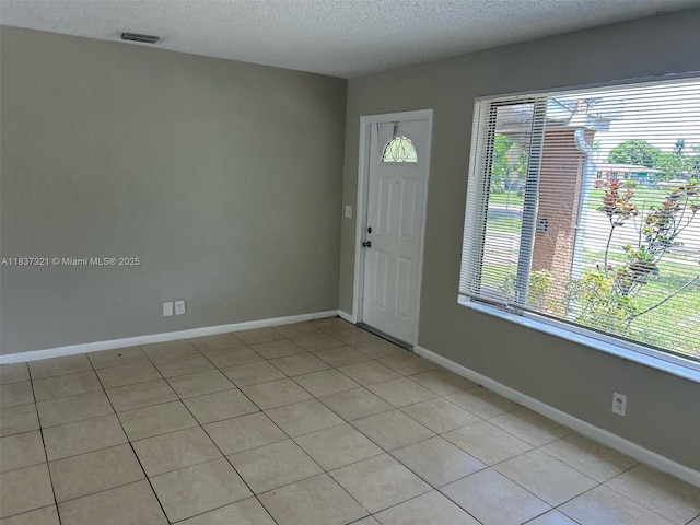 4021 NW 7th Ave, Deerfield Beach, FL 33064 - foyer with a textured ceiling and light tile patterned floors