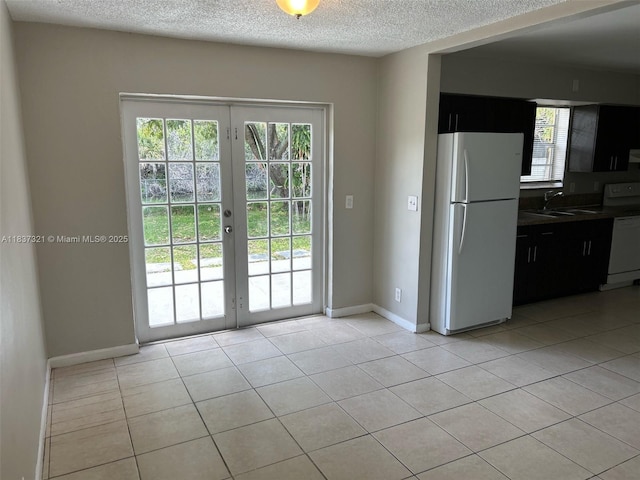 4021 NW 7th Ave, Deerfield Beach, FL 33064 - doorway to outside with french doors, light tile patterned floors, and a textured ceiling
