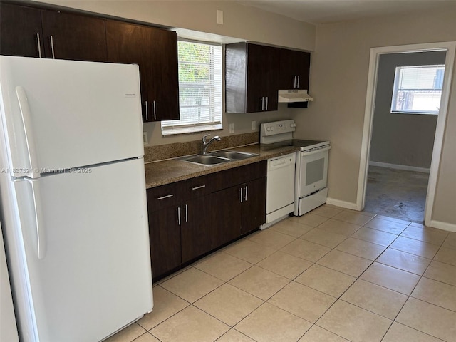 4021 NW 7th Ave, Deerfield Beach, FL 33064 - kitchen with white appliances, under cabinet range hood, light tile patterned floors, and dark brown cabinetry