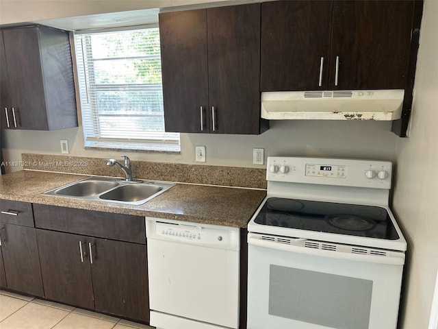 4021 NW 7th Ave, Deerfield Beach, FL 33064 - kitchen with white appliances, under cabinet range hood, dark brown cabinetry, and light tile patterned flooring