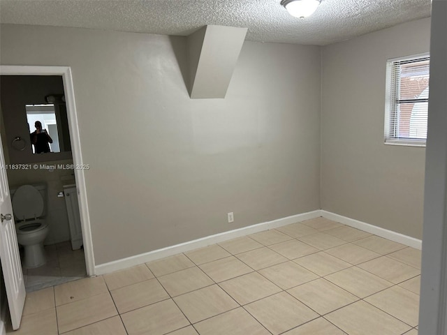4021 NW 7th Ave, Deerfield Beach, FL 33064 - unfurnished room featuring light tile patterned flooring and a textured ceiling