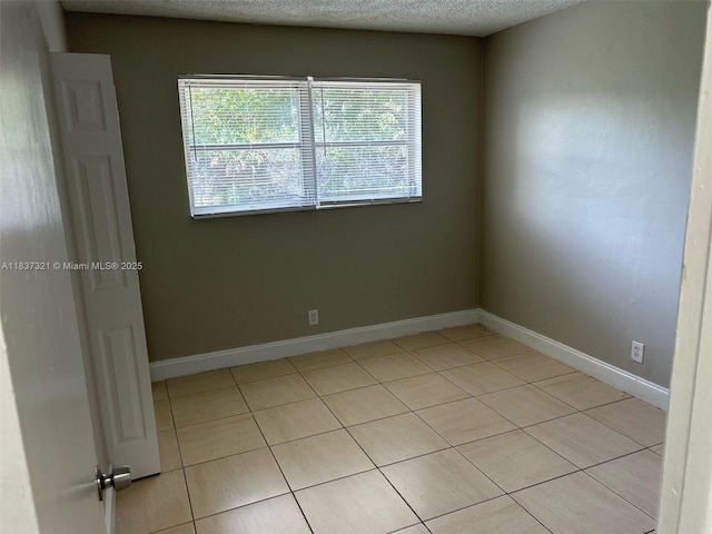 4021 NW 7th Ave, Deerfield Beach, FL 33064 - unfurnished room with light tile patterned flooring and a textured ceiling