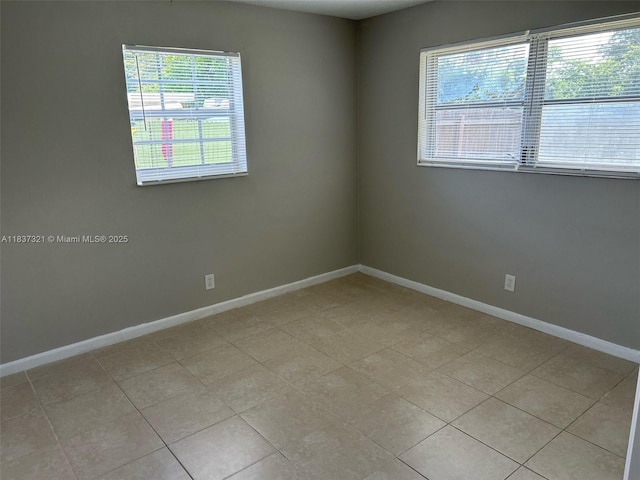4021 NW 7th Ave, Deerfield Beach, FL 33064 - unfurnished room featuring baseboards and light tile patterned flooring