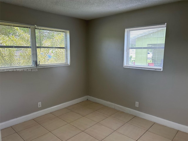 4021 NW 7th Ave, Deerfield Beach, FL 33064 - unfurnished room with light tile patterned flooring and a textured ceiling