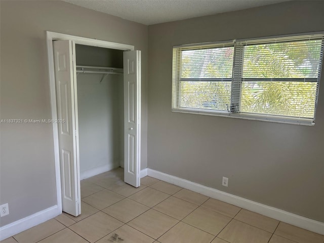 4021 NW 7th Ave, Deerfield Beach, FL 33064 - unfurnished bedroom with light tile patterned floors and a closet