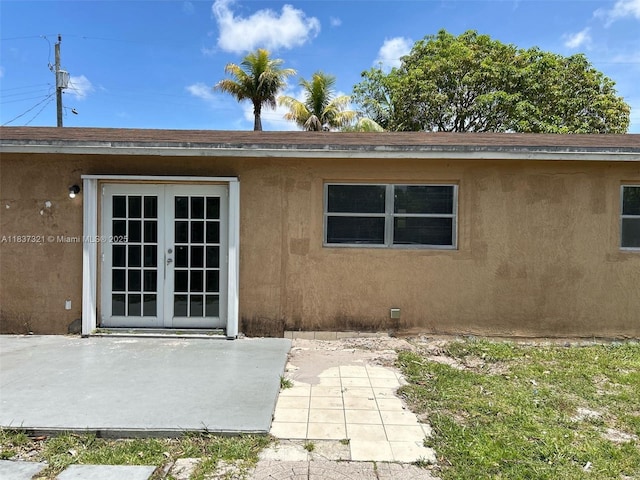 4021 NW 7th Ave, Deerfield Beach, FL 33064 - property entrance featuring french doors, stucco siding, and a patio