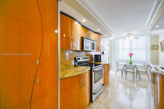 2751 S Ocean Dr Unit 1707S, Hollywood, FL 33019 - kitchen with appliances with stainless steel finishes, backsplash, brown cabinetry, a ceiling fan, and light tile patterned floors