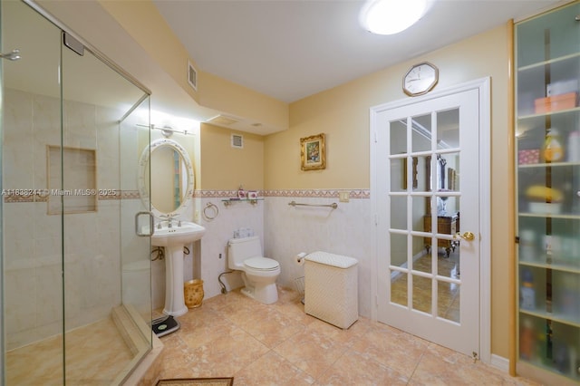 2751 S Ocean Dr Unit 1707S, Hollywood, FL 33019 - full bath with tile walls, a shower stall, tile patterned floors, and a wainscoted wall