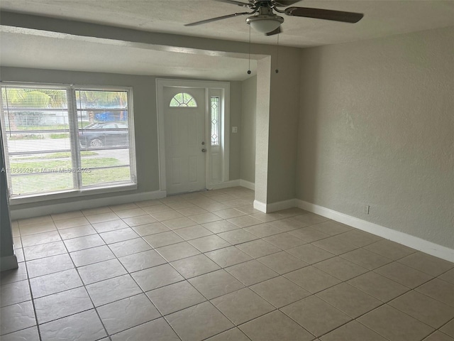 5456 NW 1st Ave, Oakland Park, FL 33309 - foyer entrance with a textured wall, ceiling fan, and tile patterned flooring