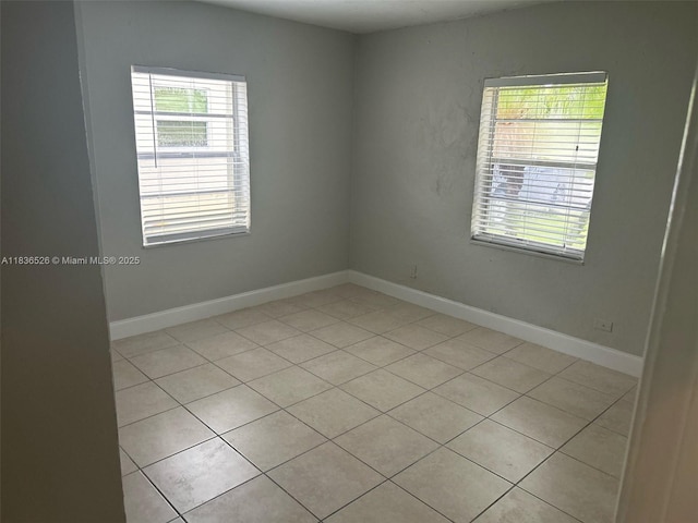 5456 NW 1st Ave, Oakland Park, FL 33309 - empty room featuring plenty of natural light and light tile patterned floors