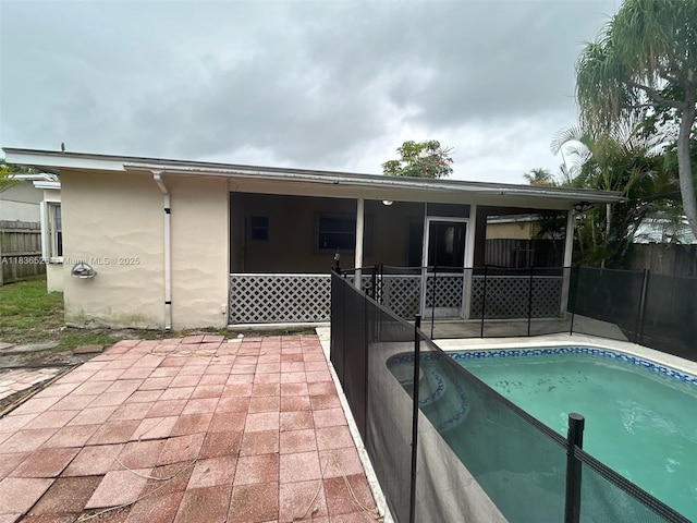 5456 NW 1st Ave, Oakland Park, FL 33309 - rear view of house with stucco siding, a sunroom, and a patio area