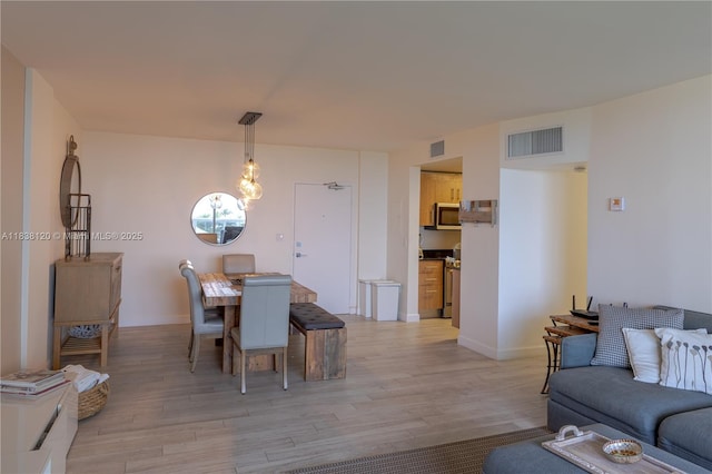 10275 Collins Ave Unit 634, Bal Harbour, FL 33154 - dining space featuring light wood finished floors and baseboards