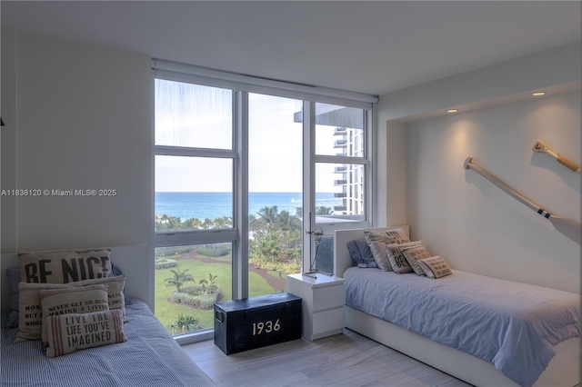 10275 Collins Ave Unit 634, Bal Harbour, FL 33154 - bedroom featuring a water view, wood finished floors, and expansive windows
