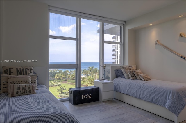 10275 Collins Ave Unit 634, Bal Harbour, FL 33154 - bedroom with multiple windows, wood finished floors, a water view, and recessed lighting