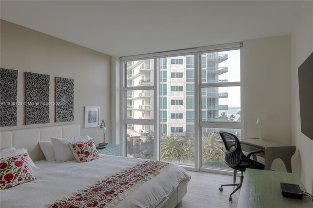 10275 Collins Ave Unit 634, Bal Harbour, FL 33154 - bedroom featuring multiple windows, a wall of windows, and wood finished floors