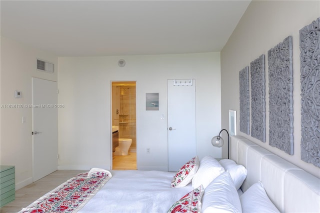 10275 Collins Ave Unit 634, Bal Harbour, FL 33154 - bedroom with ensuite bath and light wood-style flooring
