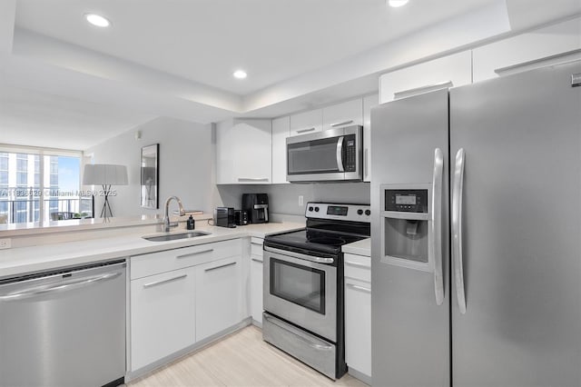 555 NE 15th St Unit 11D, Miami, FL 33132 - kitchen featuring stainless steel appliances, white cabinetry, light countertops, recessed lighting, and a tray ceiling