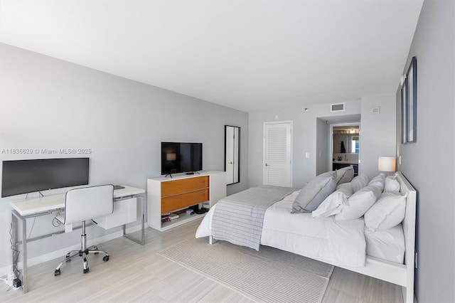 555 NE 15th St Unit 11D, Miami, FL 33132 - bedroom with wood finished floors and a desk