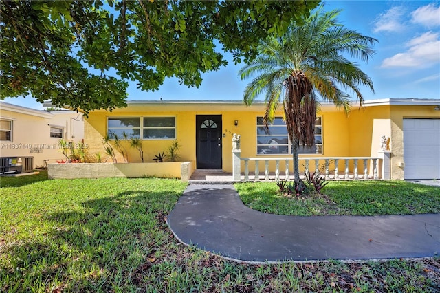 9540 NW 25th St, Sunrise, FL 33322 - view of front of property with stucco siding, an attached garage, and a front yard