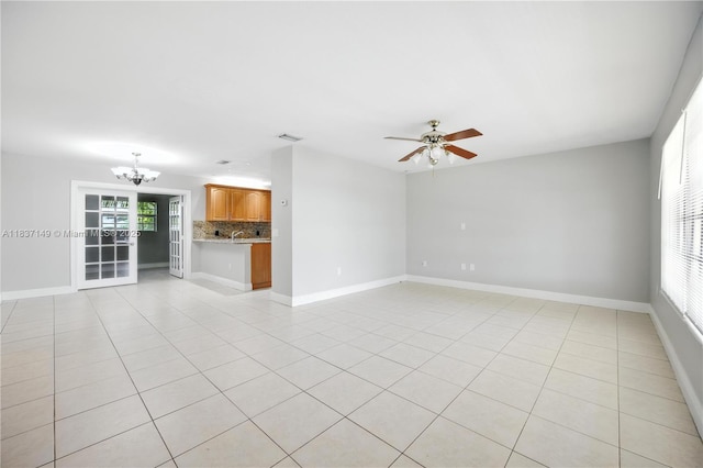 9540 NW 25th St, Sunrise, FL 33322 - unfurnished living room featuring a chandelier, light tile patterned flooring, and ceiling fan