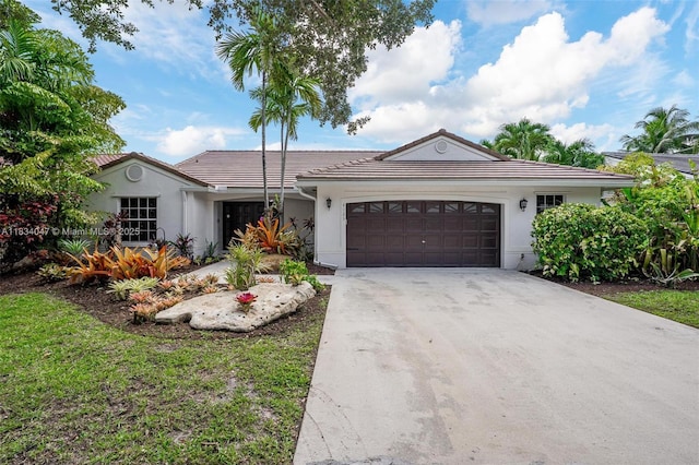 4125 SW 152nd Ave, Miramar, FL 33027 - single story home with a tile roof, a garage, stucco siding, and driveway