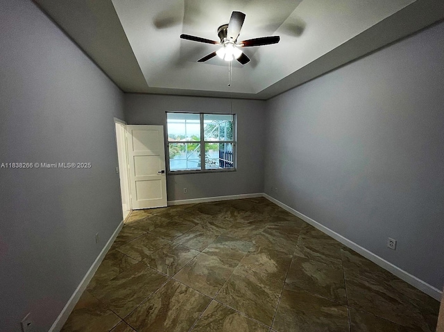 10824 Fillmore Dr, Boynton Beach, FL 33437 - empty room featuring a raised ceiling and a ceiling fan